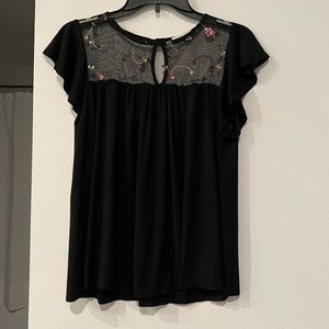 Black blouse with some florals embroidered.